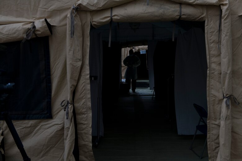 A U.S. Air Force Airman dons personal protective equipment prior to conducting COVID-19 testing March 25, 2020, at Travis Air Force Base, California. The testing location, which is located outside the emergency room of David Grant USAF Medical Center, is one of two sites the base is providing to support COVID-19 testing. (U.S. Air Force photo by Tech. Sgt. James Hodgman)