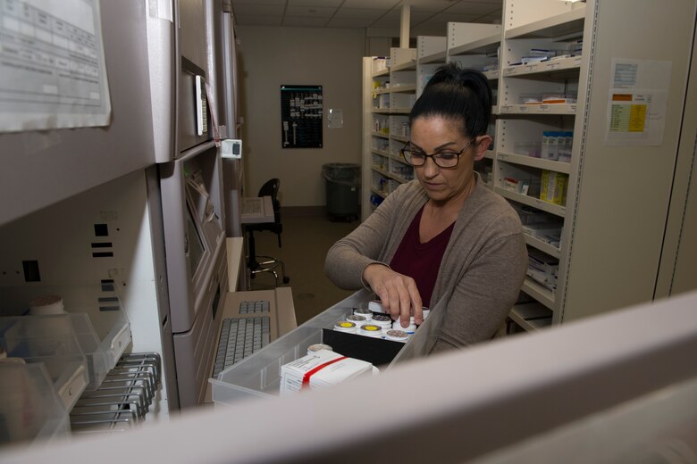 Tamra Cummins, 60th Diagnostics and Therapeutics Squadron pharmacy technician, completes a narcotics count inside the Satellite Pharmacy March 25, 2020, at Travis Air Force Base, California. The pharmacy, which is located inside the Base Exchange mini mall, is one of many services the 60th Medical Group is providing during the COVID-19 pandemic. (U.S. Air Force photo by Tech. Sgt. James Hodgman)