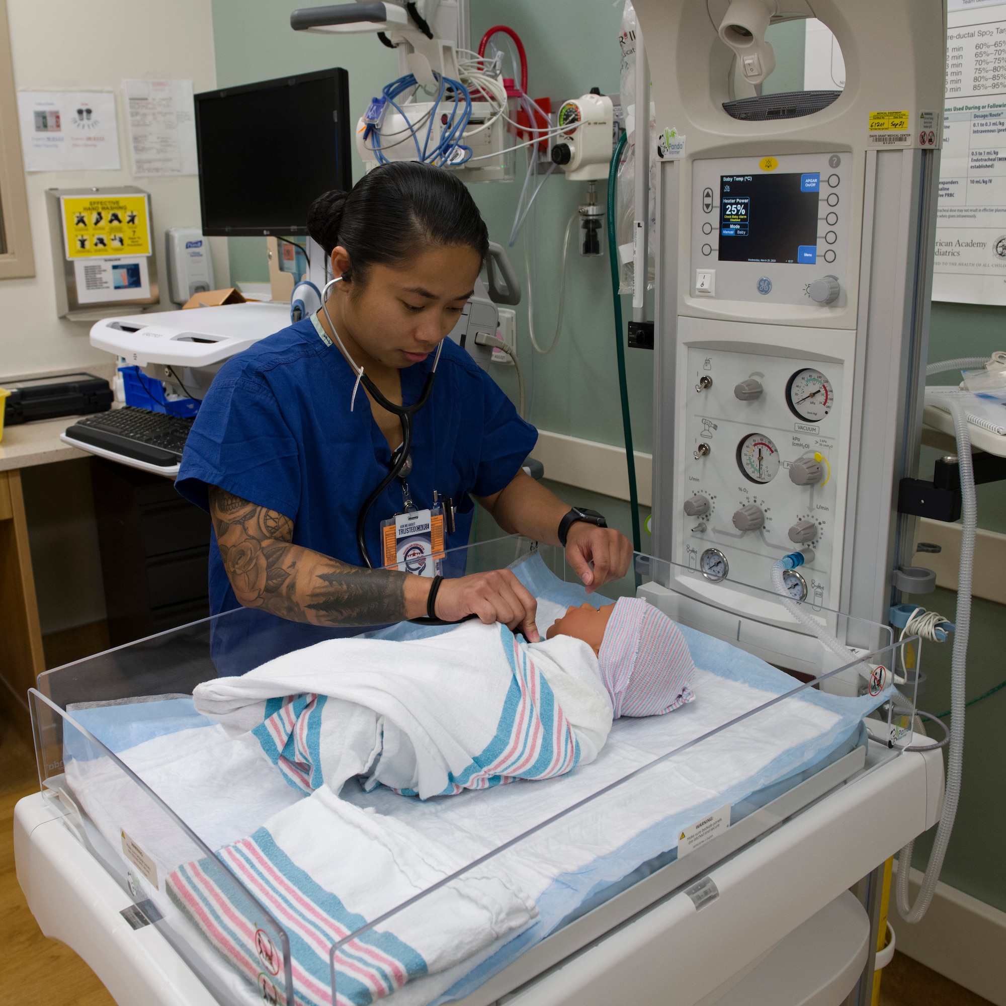 U.S. Air Force Senior Airman Lorena Blodgeth, 60th Inpatient Squadron medical technician, demonstrates how to check a baby’s heartbeat March 25, 2020, at Travis Air Force Base, California. Blogdeth works in the Labor and Delivery section of David Grant USAF Medical Center, which is one of many clinics still operating during the COVID-19 pandemic. (U.S. Air Force photo by Tech. Sgt. James Hodgman)