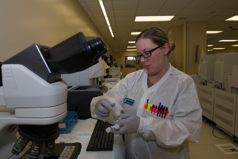 U.S. Air Force Senior Airman Brittany Campbell, 60th Medical Diagnostics and Therapeutics Squadron lab technician, prepares urinalysis samples for testing March 25, 2020, inside the lab at David Grant USAF Medical Center at Travis Air Force Base, California. The lab, which supports Air Mobility Command, as well as the Pacific theater, is one of many services the medical center is providing during the COVID-19 pandemic. (U.S. Air Force photo by Tech. Sgt. James Hodgman)