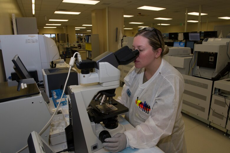 U.S. Air Force Senior Airman Brittany Campbell, 60th Medical Diagnostics and Therapeutics Squadron lab technician, analyzes a urinalysis sample March 25, 2020, inside the lab at David Grant USAF Medical Center at Travis Air Force Base, California. The lab, which supports Air Mobility Command, as well as the Pacific theater, is one of many services the medical center is providing during the COVID-19 pandemic. (U.S. Air Force photo by Tech. Sgt. James Hodgman)