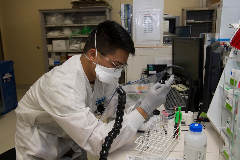 U.S. Air Force Airman 1st Class Michael San Jose, 60th Medical Diagnostics and Therapeutics Squadron lab technician, performs antibody titration inside the David Grant USAF Medical Center laboratory March 25, 2020, at Travis Air Force Base, California. The lab, which supports Air Mobility Command, as well as the Pacific theater, is one of many services the medical center is providing during the COVID-19 pandemic. (U.S. Air Force photo by Tech. Sgt. James Hodgman)