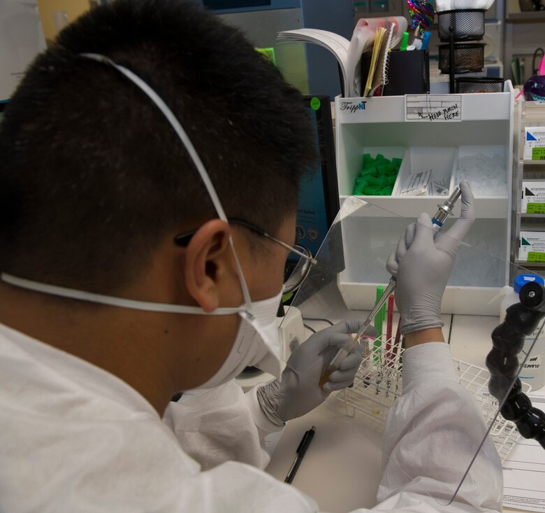 U.S. Air Force Airman 1st Class Michael San Jose, 60th Medical Diagnostics and Therapeutics Squadron lab technician, performs antibody titration inside the David Grant USAF Medical Center laboratory March 25, 2020, at Travis Air Force Base, California. The lab, which supports Air Mobility Command, as well as the Pacific theater, is one of many services the medical center is providing during the COVID-19 pandemic. (U.S. Air Force photo by Tech. Sgt. James Hodgman)