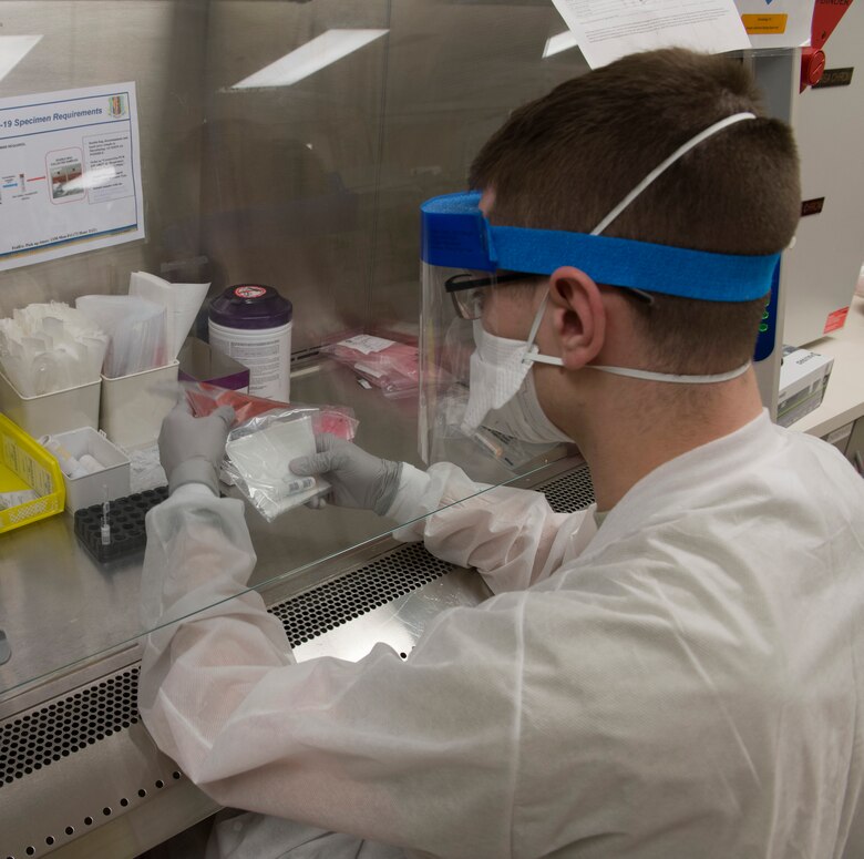U.S. Air Force Airman 1st Class Elmendorf Thomas, 60th Medical Diagnostics and Therapeutics Squadron laboratory technician, reviews patient information after a COVID-19 test was completed inside the David Grant USAF Medical Center laboratory March 25, 2020, at Travis Air Force Base, California. The lab, which supports Air Mobility Command, as well as the Pacific theater, is one of many services the medical center is providing during the COVID-19 pandemic. The medical center has offered COVID-19 testing since March 17. (U.S. Air Force photo by Tech. Sgt. James Hodgman)