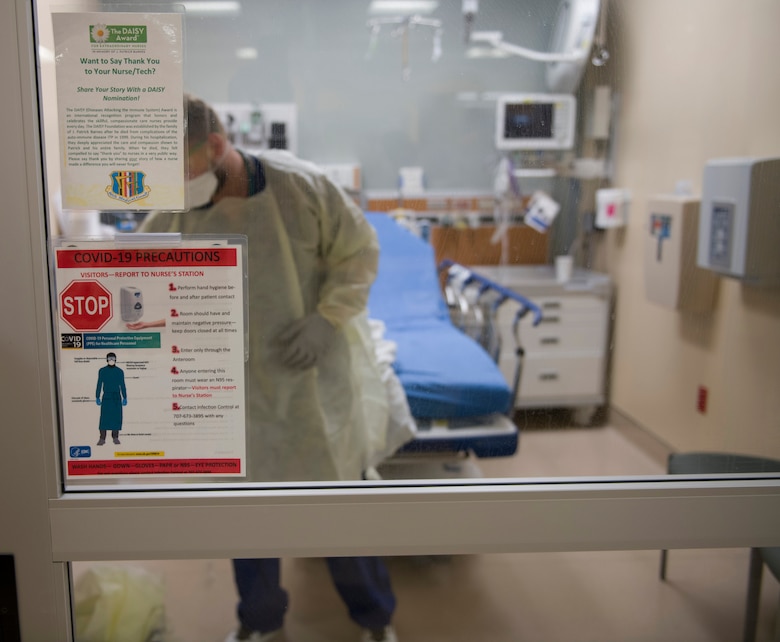 Wayne Hennigan, 60th Medical Group Emergency Department registered nurse, cleans an exam room inside David Grant USAF Medical Center March 25, 2020, at Travis Air Force Base, California. The emergency department, which is open 24/7, is one of many services the medical center is providing during the COVID-19 pandemic. (U.S. Air Force photo by Tech. Sgt. James Hodgman)