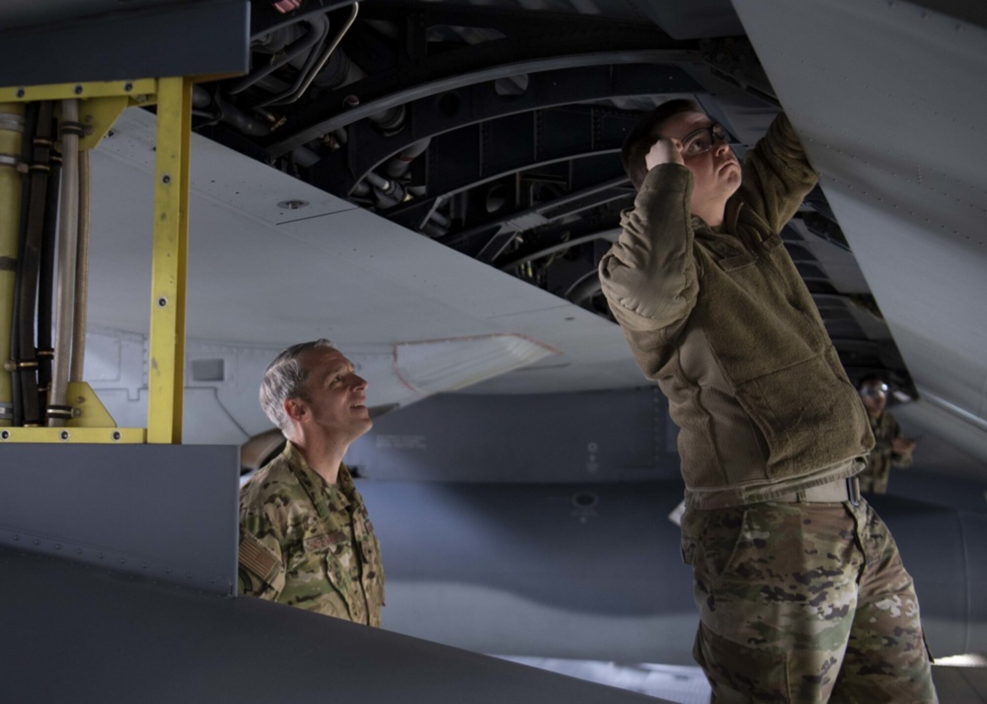 Airmen work on an aircraft