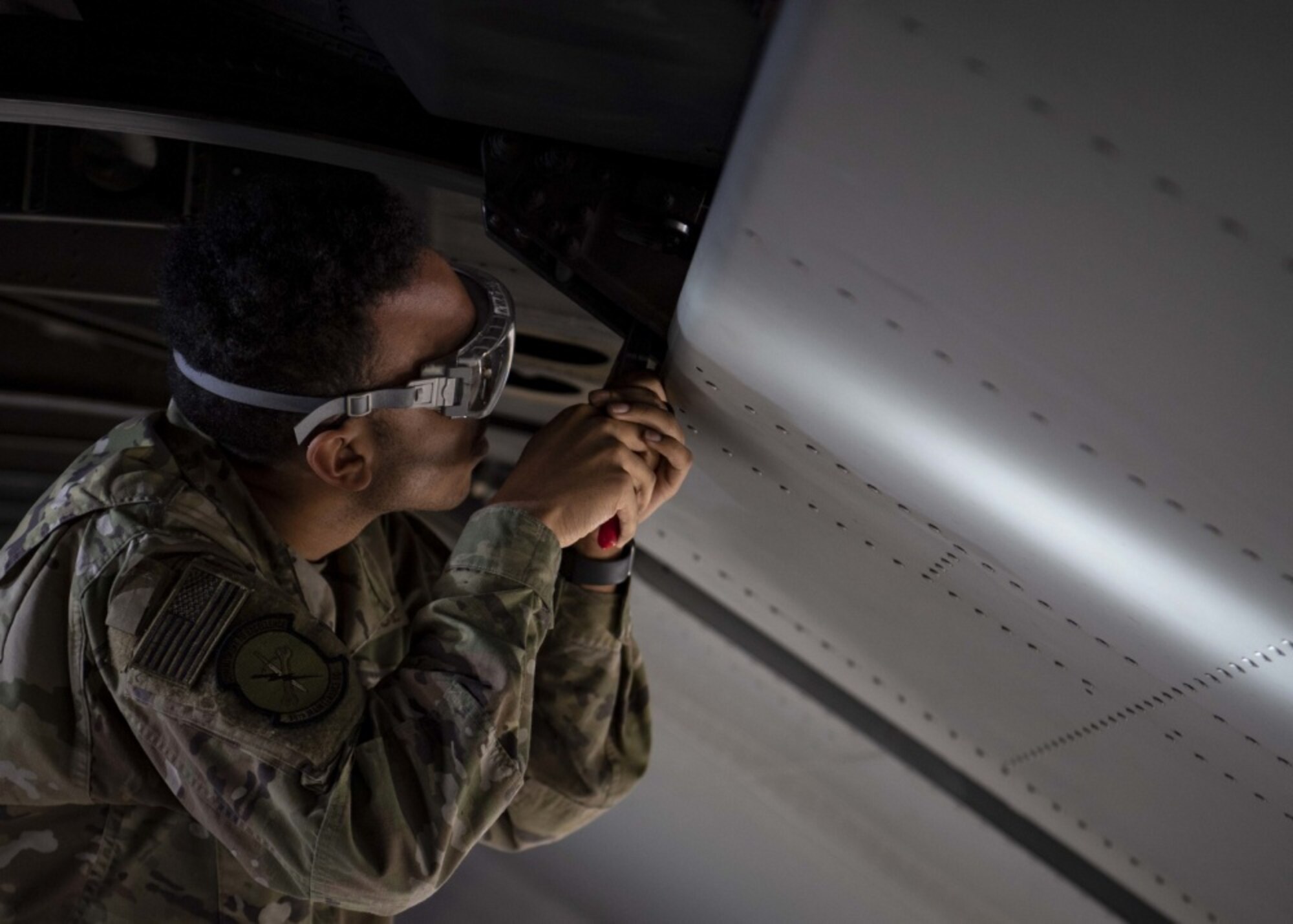 An Airmen works on an aircraft