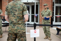 A sailor speaks to other service members.