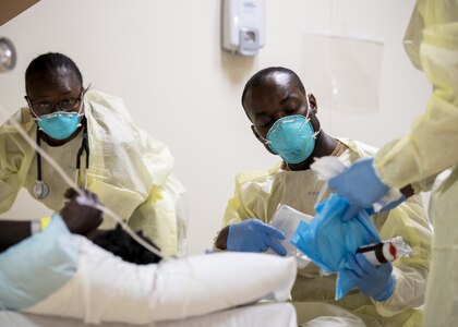 Hospital staff care for a patient.