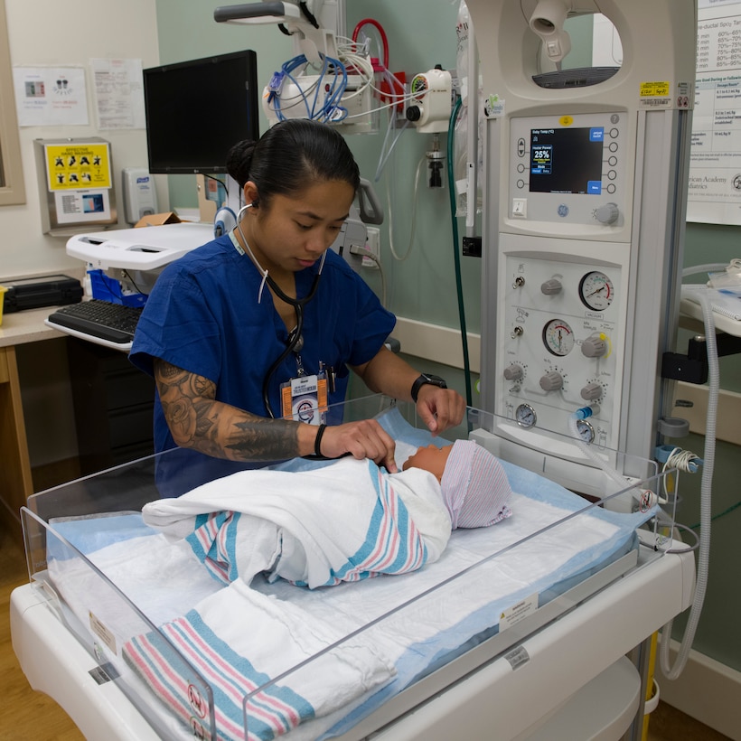 U.S. Air Force Senior Airman Lorena Blodgeth, 60th Inpatient Squadron medical technician, demonstrates how to check a baby’s heartbeat March 25, 2020, at Travis Air Force Base, California. Blogdeth works in the Labor and Delivery section of David Grant USAF Medical Center, which is one of many clinics still operating during the COVID-19 pandemic. (U.S. Air Force photo by Tech. Sgt. James Hodgman)