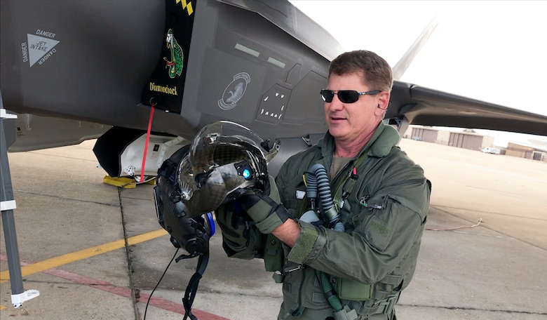 Col. Brian Silkey, 419th Fighter Wing vice commander, shows off the F-35 helmet to an online audience during a 