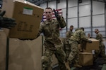 Medical supplies are unloaded from the New England Patriots team plane and onto Massachusetts National Guard tactical vehicles for transportation from Logan Airport in Boston, April 2, 2020. The Mass.National Guard is providing logistical support to civil authorities throughout the Commonwealth as part of the battle against COVID-19.