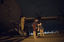 Capt. Garrett Iapicco, 40th Airlift Squadron pilot, escorts a family off of a C-130J Super Hercules at Joint Base Charleston, S.C. April 1, 2020. The passengers were flown from Soto Cano Air Base, Honduras.The American citizens were transported to JB Charleston as part of an ongoing interagency effort led by the U.S. State Department to assist American citizens unable to return home from countries around the world during the COVID-19 pandemic.