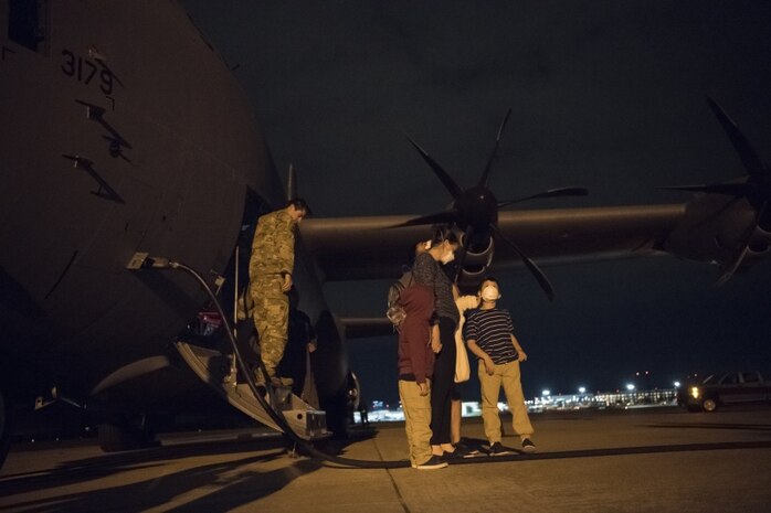 Capt. Garrett Iapicco, 40th Airlift Squadron pilot, escorts a family off of a C-130J Super Hercules at Joint Base Charleston, S.C. April 1, 2020. The passengers were flown from Soto Cano Air Base, Honduras.The American citizens were transported to JB Charleston as part of an ongoing interagency effort led by the U.S. State Department to assist American citizens unable to return home from countries around the world during the COVID-19 pandemic.