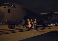 Passengers wait outside of a C-130J Super Hercules at Joint Base Charleston, S.C. April 1, 2020. The passengers were flown from Soto Cano Air Base, Honduras. The American citizens were transported to JB Charleston as part of an ongoing interagency effort led by the U.S. State Department to assist American citizens unable to return home from countries around the world during the COVID-19 pandemic.(U.S. Air Force photo by Senior Airman Joshua R. Maund)