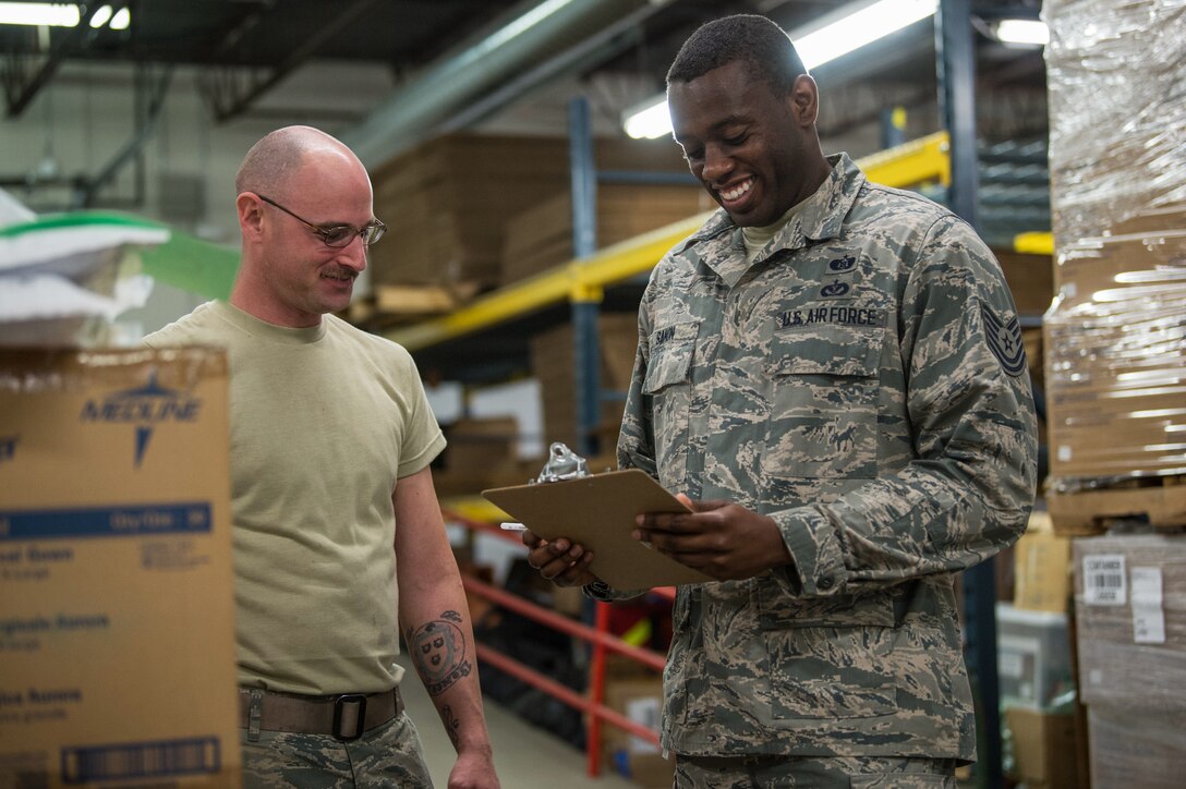 Staff Sgt. Keith Gomo from the Logistics Readiness Squadron and Tech. Sgt. Gladimir Sanon from Civil Engineer Squadron, 158th Fighter Wing, Vermont Air National Guard, assist the Vermont Department of Health with unloading pallets of medical supplies and organizing them for redistribution to strategic locations throughout the state, at a distribution center in Vermont.