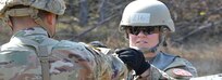 U.S. Army Sgt. Faith Dawson, right, assigned to Task Force Sinai, demonstrates the proper knot for securing a litter onto the back of a Humvee during testing for the Expert Field Medical Badge at the 7th Army Training Command’s Grafenwoehr Training Area, Germany, March 29, 2019. To qualify for the badge, Soldiers from U.S. Army Europe, NATO, and other allied and partner nations must complete events such as land navigation, weapons function checks, written tests, medical treatments and evacuations, and a 12 mile ruck march. (U.S. Army photo by Spc. Rolyn Kropf)