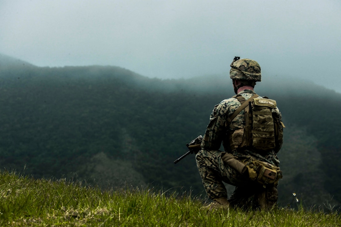 A Marine holds security during a live fire range at Central Training Area, Okinawa, Japan March 28.