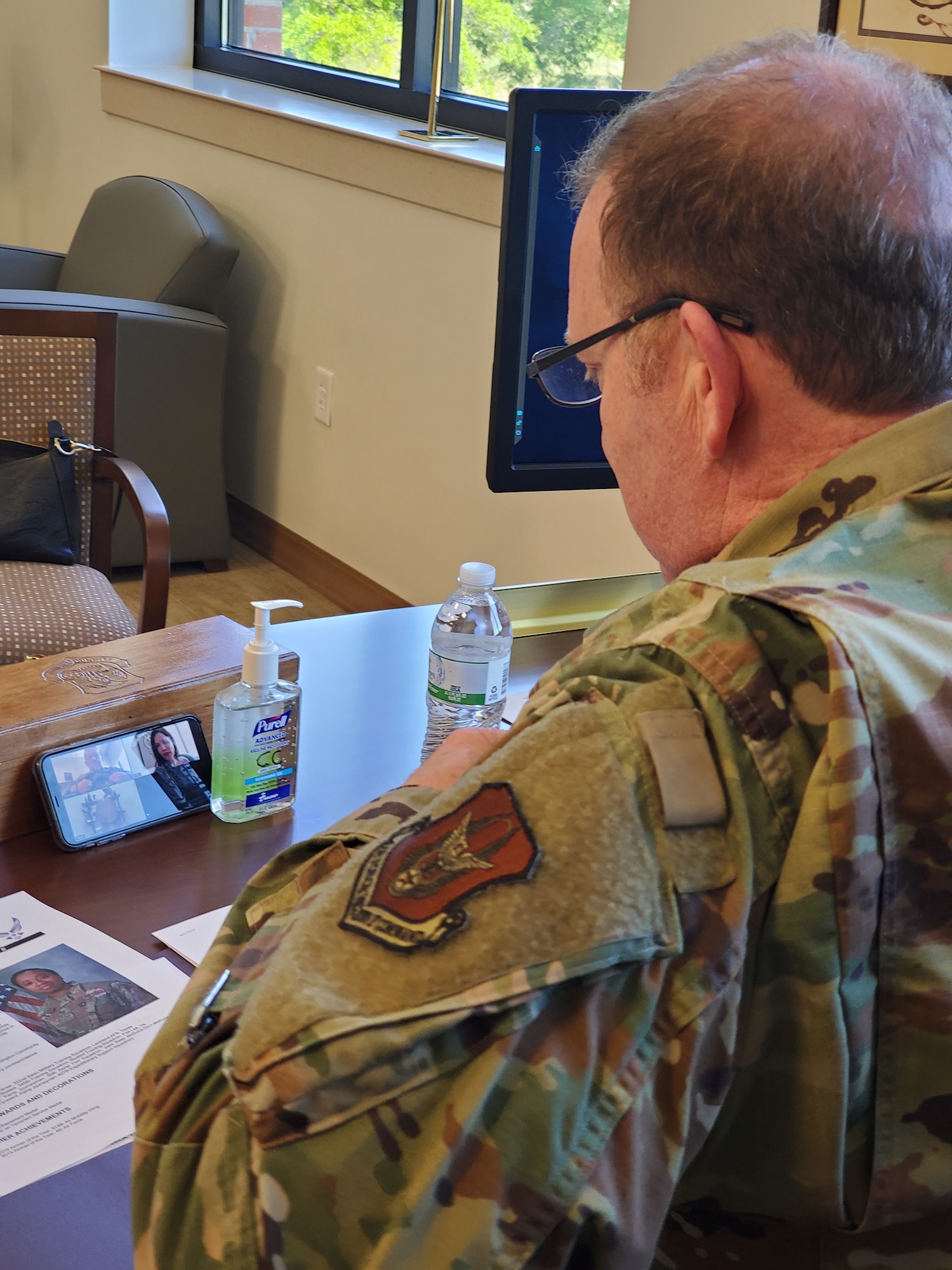 Lt. Gen. Richard Scobee, Air Force Reserve Command commander, uses his cell phone to video chat with one of AFRC’s new outstanding Airmen of the year award winners. Since this year’s OAY banquet had to be cancelled, senior leaders surprised the winners with teleconferences on April 2. (U.S. Air Force photo by Senior Master Sgt. Virginia Wynn)