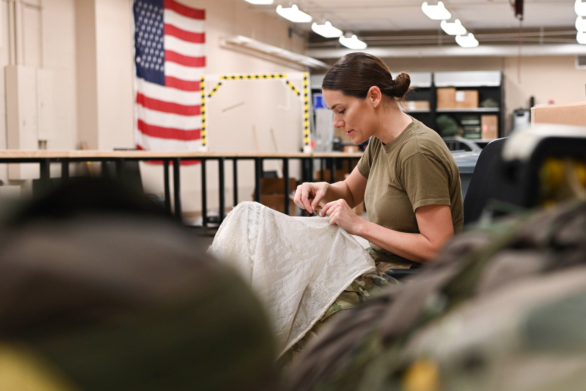 Photo of Airman repairing drag chute.