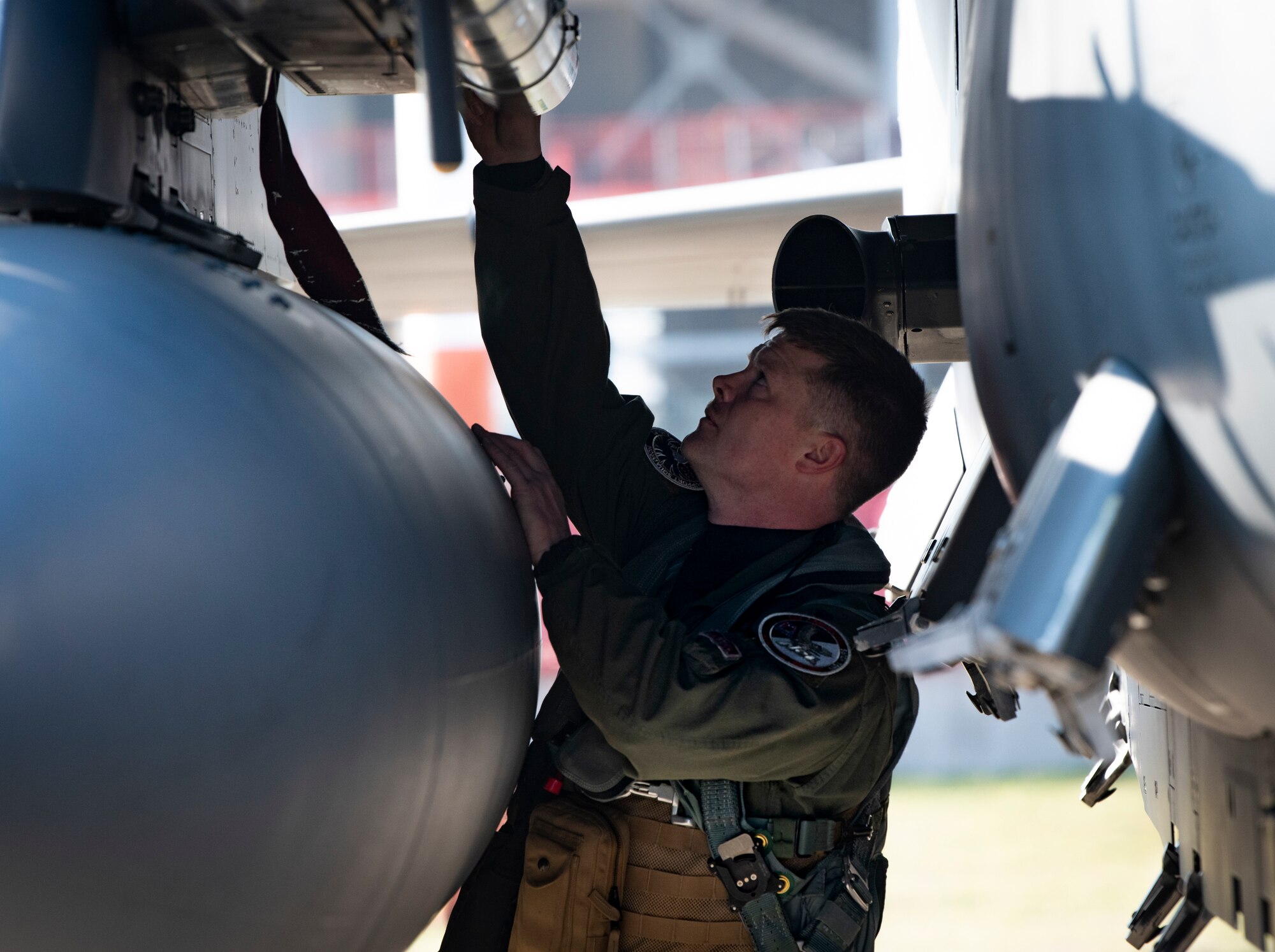 Commander conducts pre-flight checks on his aircraft