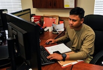 Senior Airman Jebren Medina, a 628th Logistics Readiness Squadron vehicle mechanic, works in his office at Joint Base Charleston, S.C., March 30, 2020.