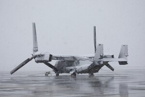 Snow falls on a CV-22 Osprey