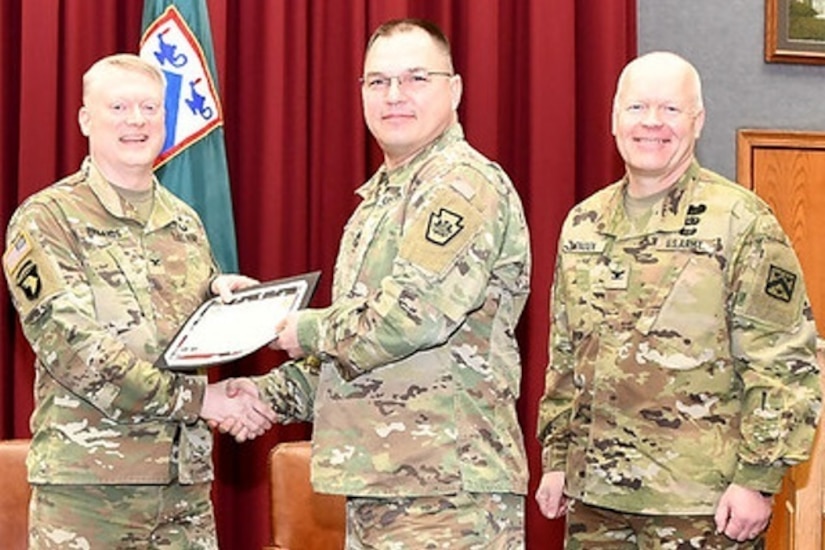 Master Sgt. John Paul Karpovich (center) receives the Army SHARP Academy’s Spirit Award from Col. Alexander Pickands (left), Fort Leavenworth Combined Arms Center staff judge advocate, on March 6. At right is Col. Christopher Engen, director of the Army SHARP Academy. Karpovich works full time as the noncommissioned officer in charge of the G1 operations section at the PNG’s Joint Force Headquarters at Fort Indiantown Gap. (U.S. Army National Guard courtesy photo)