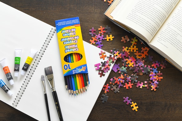 Various activities and crafts lay on a coffee table inside of Corvias Military Living April 2, 2020 at McConnell Air Force Base, Kansas. For the approximately 1,200 Airmen and their families living in military housing, it can be easy to feel disconnected while practicing physical distancing.