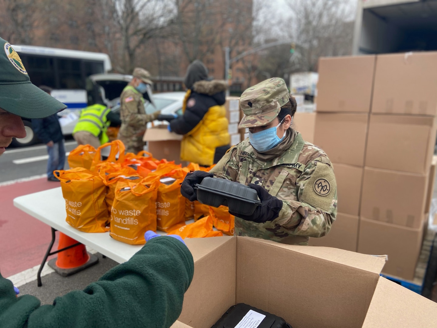 New York Army National Guard Spc. Thalio Hinajosa, assigned to Battery B, 1st Battalion, 258th Field Artillery, part of the 27th Infantry Brigade Combat Team, packs meals for distribution to the community at the Thomas Jefferson Recreation Center in New York City March 30, 2020. Hinajosa is one of more than 2,700 New York Guard members helping mitigate the COVID 19 pandemic.