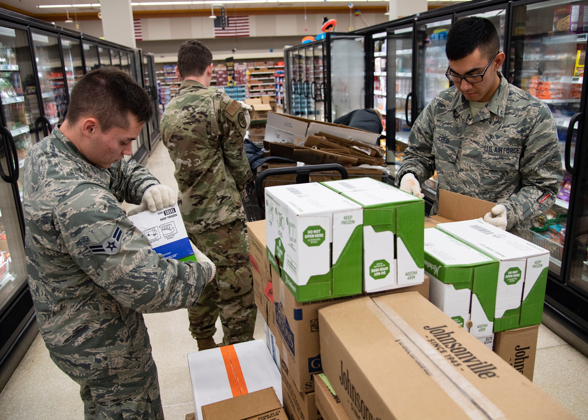 From left, Airman 1st Class Kyle Mason, Airman Bryce Jones and Airman Jackson Cribb, 362nd Training Squadron crew chief apprentice course students, help stock shelves at Sheppard Air Force Base, Texas, April 2, 2020. On March 25, 2020 all Department of Defense commissaries and other facilities were deemed mission essential. To help out those who work the hardest to supply the base, these Airmen in Training were sent from their squadrons to help with what they could. (U.S. Air Force photo by Senior Airman Pedro Tenorio)