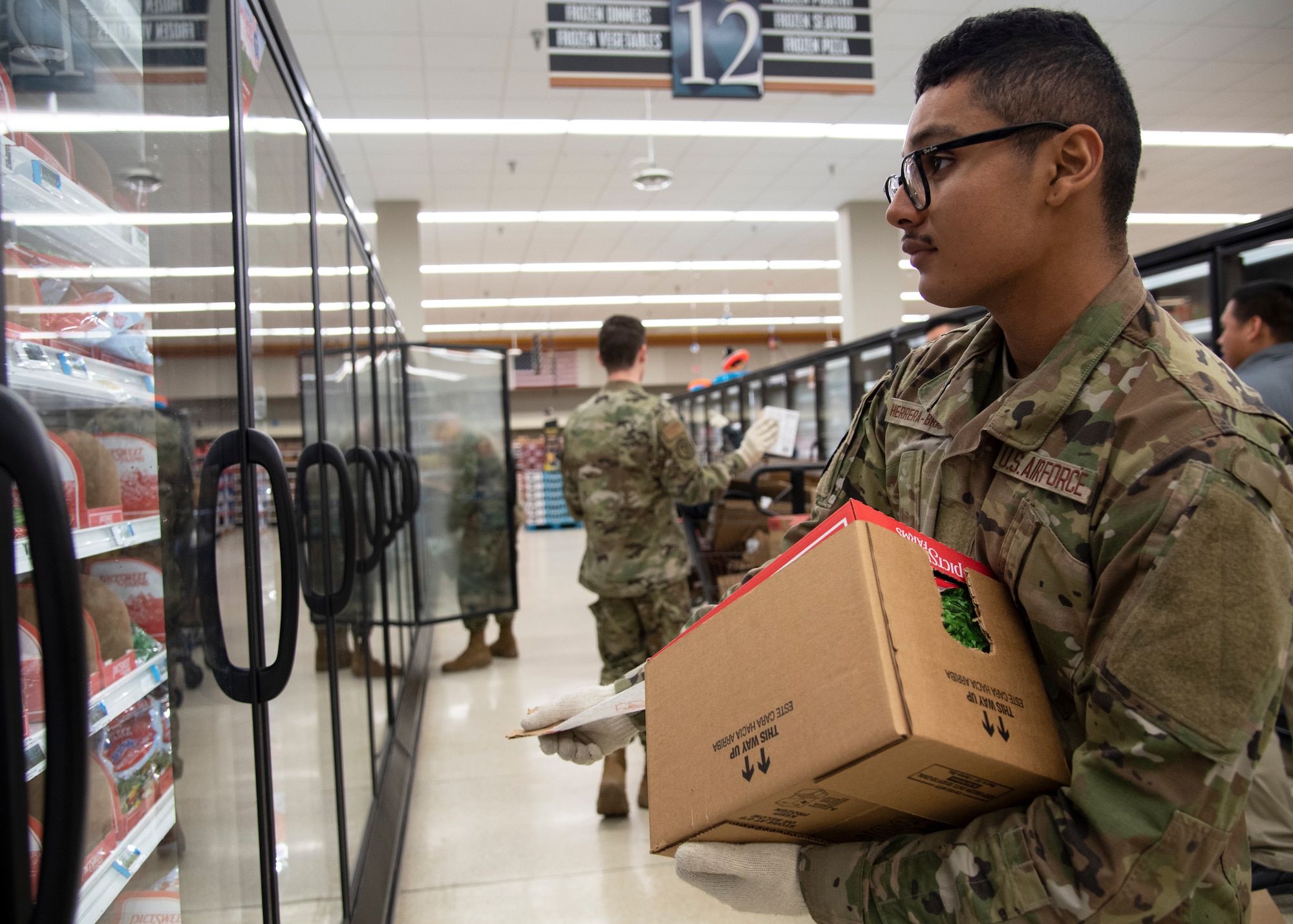 Airman Michael Herrera-Bradford, 362nd Training Squadron crew chief apprentice course students, helps stock shelves at Sheppard Air Force Base, Texas, April 2, 2020. On March 25, 2020 all Department of Defense commissaries and other facilities were deemed mission essential. To help out those who work the hardest to supply the base, these Airmen in Training were sent from their squadrons to help with what they could. (U.S. Air Force photo by Senior Airman Pedro Tenorio)