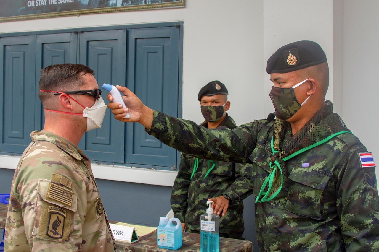 A soldier gets his temperature checked.