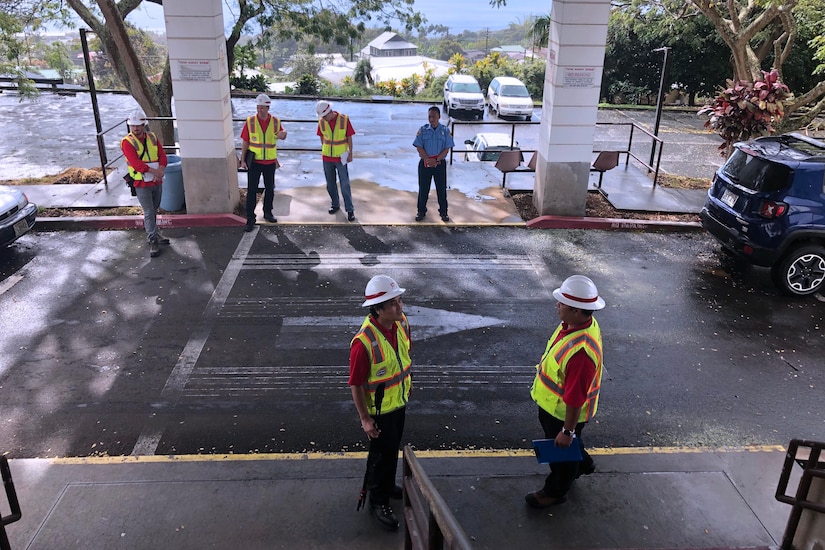 Construction team surveys space.