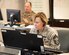 Woman in Airforce uniform types on a laptop.