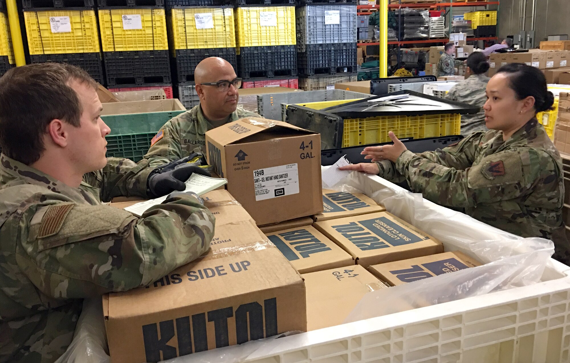 The California National Guard’s Senior Airman Mikel Chatelle, 144th Fighter Wing, Army Staff Sgt. Ivan Gallardo, Medical Detachment, and Air Force Staff Sgt. Alice Nitzsche, 144th Fighter Wing, discuss plans on how to organize medical supplies for distribution at the California Emergency Medical Services Authority facility March 20, 2020 in Sacramento, California.