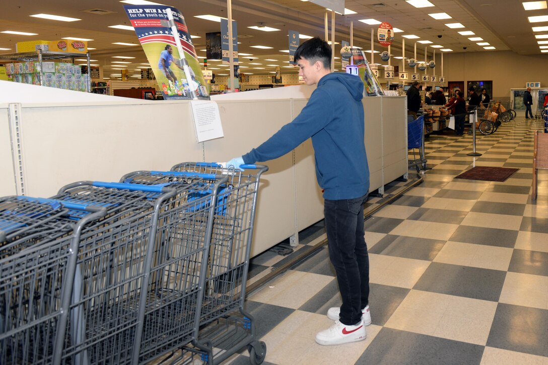 Worker sanitizes carts