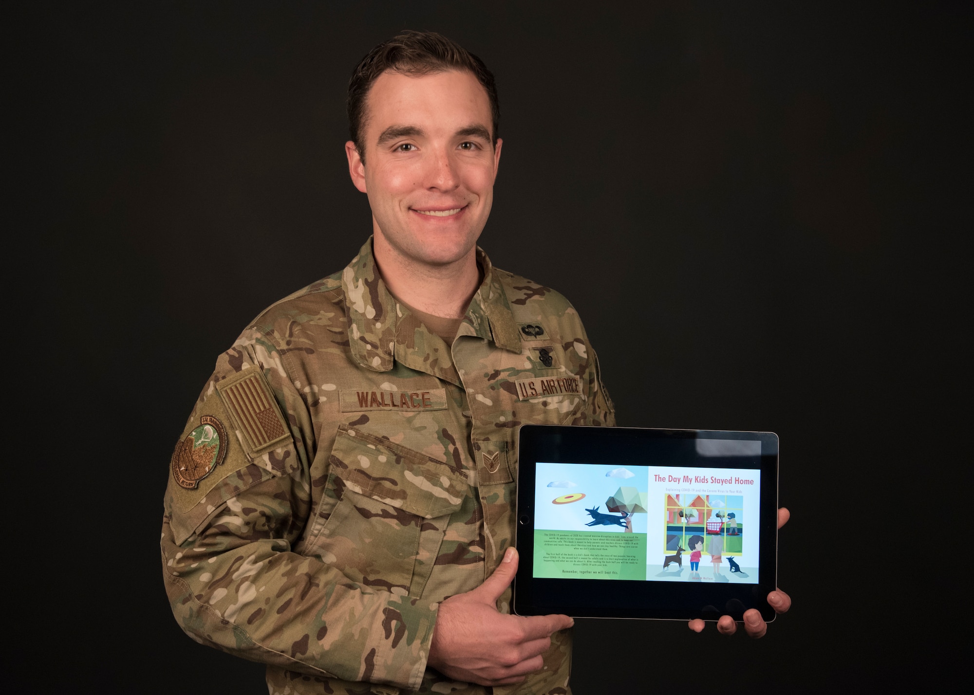 Staff Sgt. Adam Wallace, 22nd Training Squadron water survival instructor, presents a digital copy of his newly self-published children’s book “The Day My Kids Stayed Home” at Fairchild Air Force Base, Washington, April 1, 2020. Wallace conceptualized the book about a month ago at the start of the U.S. physical distancing efforts and turned out the completely illustrated text in just over two weeks. (U.S. Air Force photo Staff Sgt. Ryan Lackey)