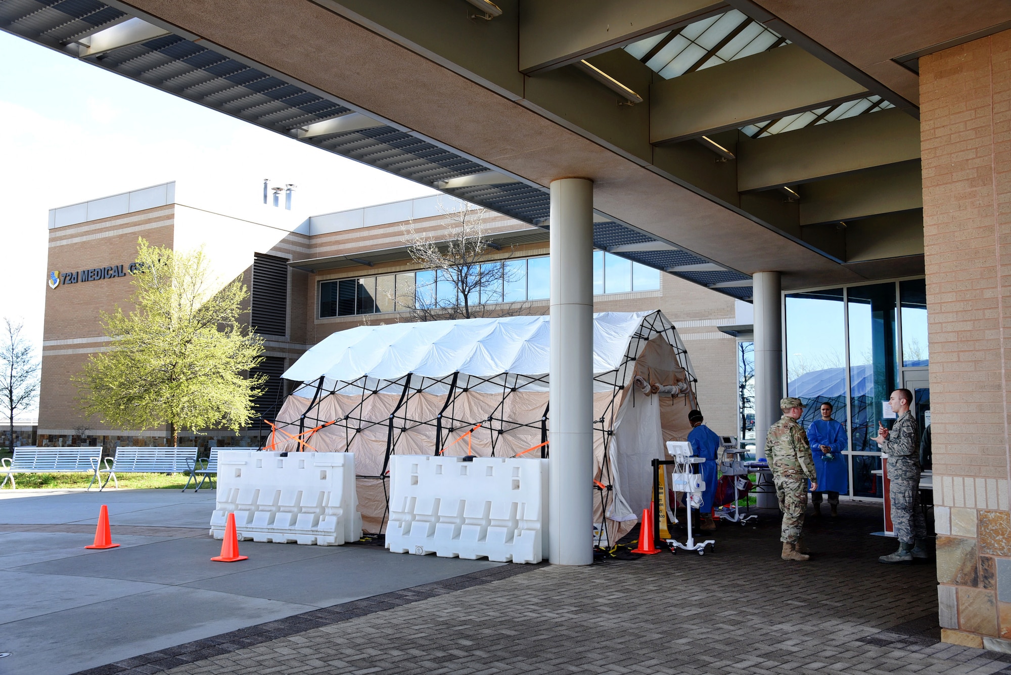 A sick tent has been installed at the front entrance of the 72nd Medical Group clinic. Medical personnel ask each incoming patient several questions to determine their path for medical care. If an individual is suspected for COVID-19, symptomatic or not, they are asked to stay in their vehicles while medical personnel dressed in containment gear asks them more extensive questions. If an individual is experiencing allergies or other upper-respiratory symptoms, they will enter a bay in the sick tent to be further evaluated. This will prevent them from entering the clinic and spreading any contamination, even if it's just a cold or flu