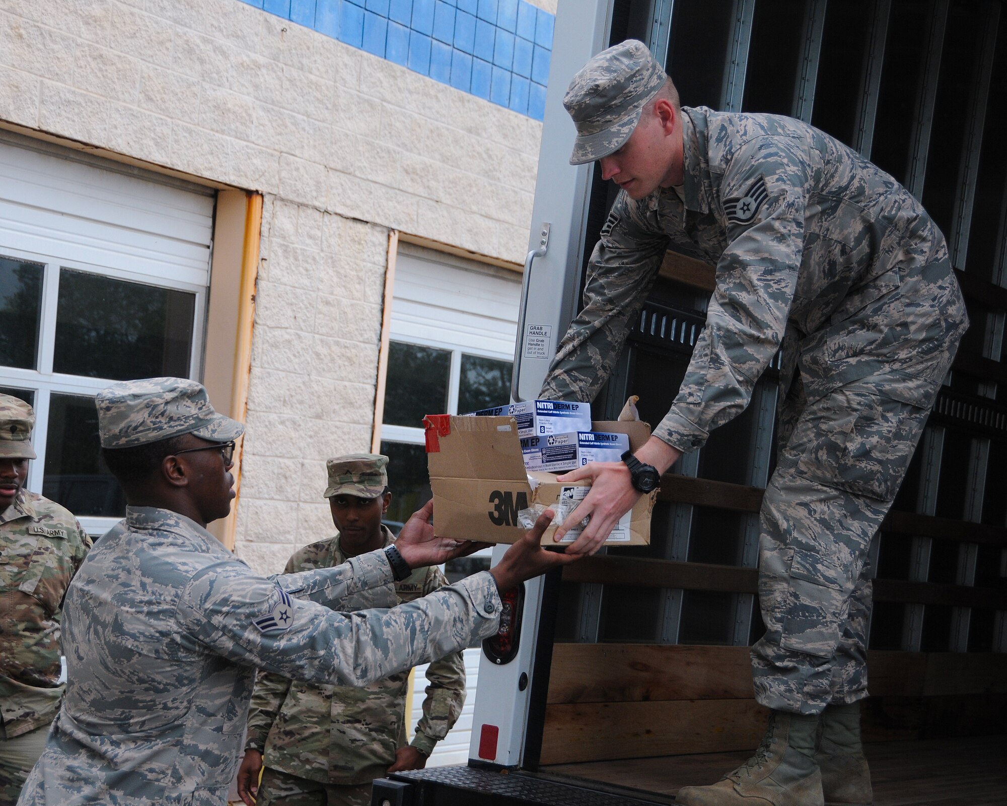 Airmen from the 186th Air Refueling Wing help unload personal protective equipment at the Bonita Lakes mobile COVID-19 testing facility, April 1, 2020, Meridian, Mississippi. Airmen and Soldiers from the Mississippi National Guard are aiding the Mississippi Department of Health and other supporting agencies to locate and stop the spread of COVID-19 around the state. (U.S. Air National Guard photo by Tech Sgt. Adam Vance)