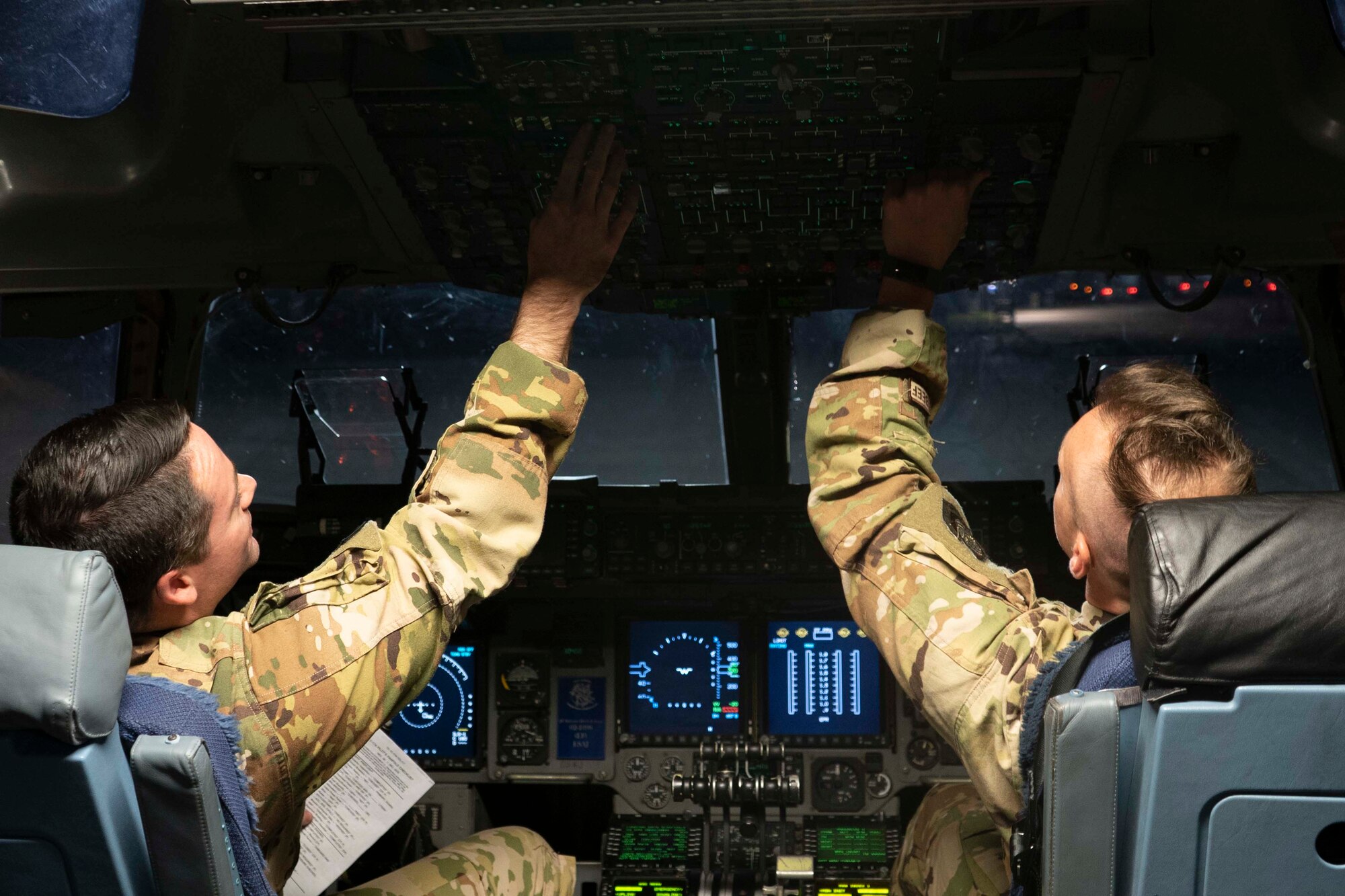 1st Lt. Bryan Burns and 2nd Lt. James Conlan perform final shutdown checks at the Memphis Air National Guard Base April 2, 2020, after flying COVID-19 test kits and other products from Aviano, Italy, to the FedEx hub in Memphis, Tenn., to be distributed to medical facilities across the U.S.