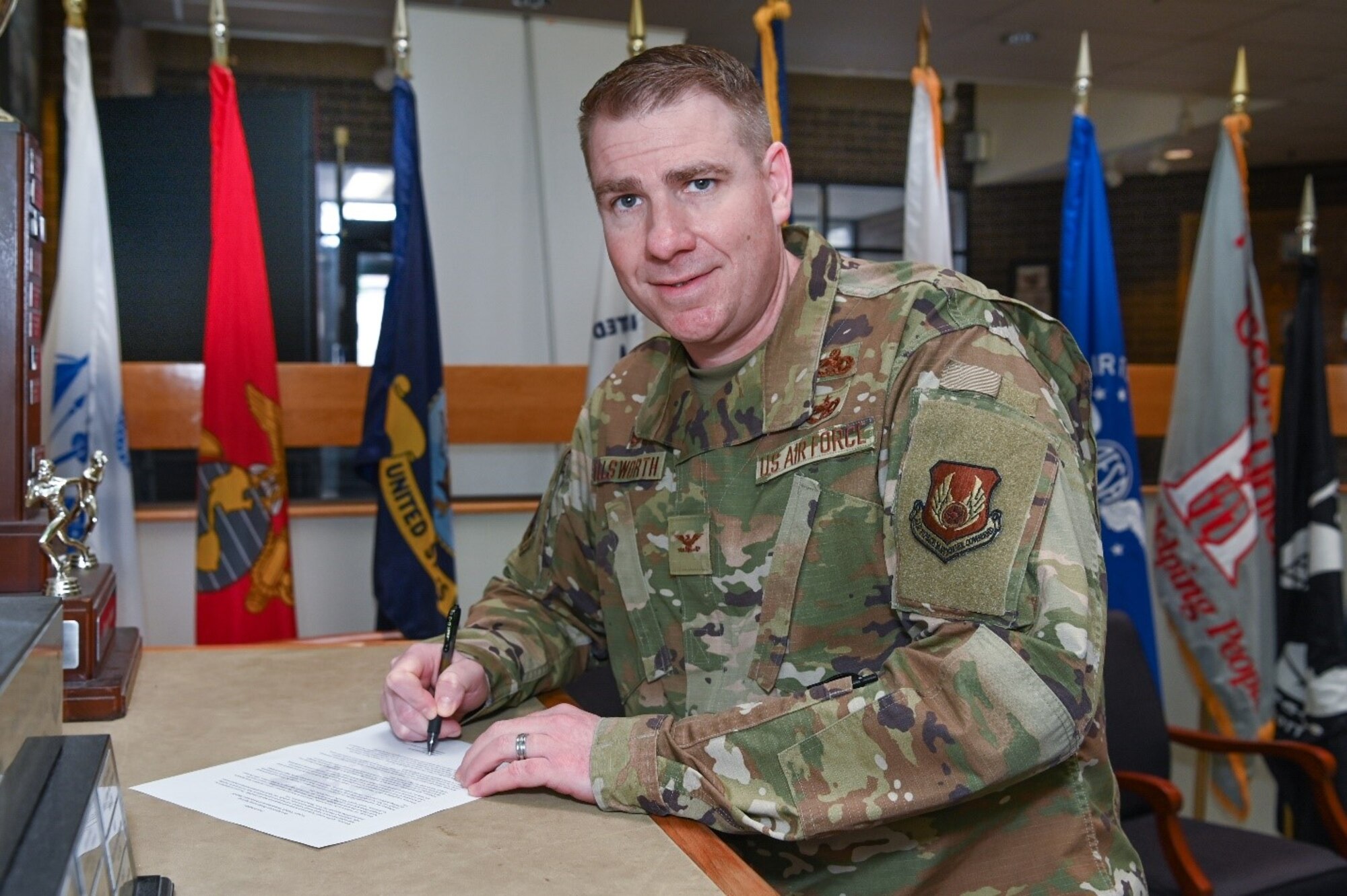 Col. Chad Ellsworth, installation commander, prepares to sign the Sexual Assault Awareness and Prevention Month proclamation at Hanscom Air Force Base, Mass., April 2. The month-long observance raises sexual assault awareness and educates community members on how to prevent it. (U.S. Air Force photo by Todd Maki)