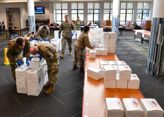 Airmen at the Halvorson Hall dining facility on Joint Base McGuire-Dix-Lakehurst, N.J., sort and pack lunches into appropriate bags that will be distributed to quarantined individuals across the installation April 2, 2020. Being the only source of nourishment during quarantine, 87th Force Support Squadron services Airmen create more than 150 meals each meal period to ensure each member is provided proper nourishment.