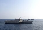 ANDAMAN SEA (April 2, 2020) The Independence-variant littoral combat ship USS Gabrielle Giffords (LCS 10), left, sails past the Japan Maritime Self-Defense Force (JMSDF) Akizuki-class destroyer JS Teruzuki (DD 116) during a cooperative deployment, April 2, 2020. Gabrielle Giffords, part of Destroyer Squadron Seven, is on a rotational deployment, operating in the U.S. 7th Fleet area of operations to enhance interoperability with partners and serve as a ready-response force.