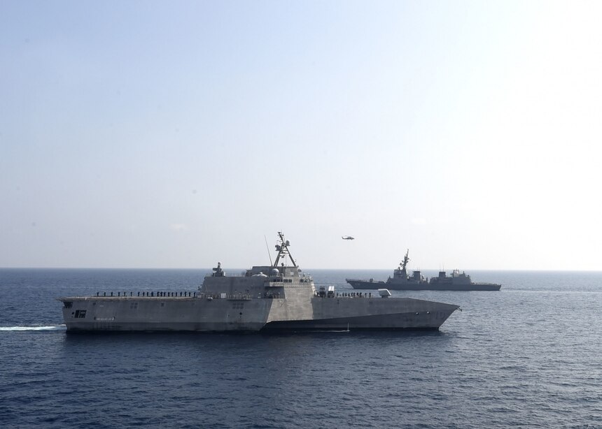 ANDAMAN SEA (April 2, 2020) The Independence-variant littoral combat ship USS Gabrielle Giffords (LCS 10), left, sails past the Japan Maritime Self-Defense Force (JMSDF) Akizuki-class destroyer JS Teruzuki (DD 116) during a cooperative deployment, April 2, 2020. Gabrielle Giffords, part of Destroyer Squadron Seven, is on a rotational deployment, operating in the U.S. 7th Fleet area of operations to enhance interoperability with partners and serve as a ready-response force.