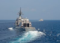 The Independence-variant littoral combat ship USS Gabrielle Giffords (LCS 10), right, sails in formations with the Japan Maritime Self-Defense Force (JMSDF) Akizuki-class destroyer JS Teruzuki (DD 116) during a cooperative deployment, April 2, 2020.