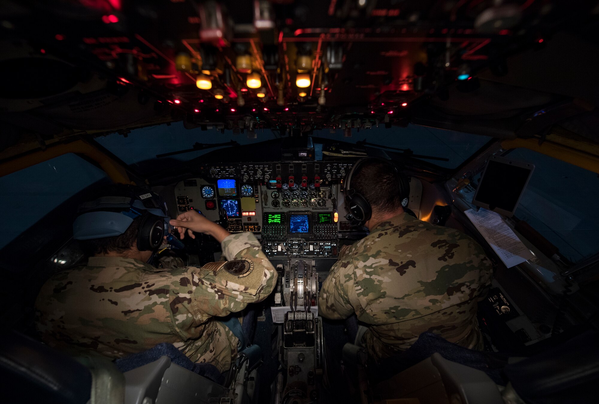 U.S. Air Force 1st Lt. Dwayne Facho, left, and U.S. Air Force Capt. Houston Harrison, 28th Expeditionary Air Refueling Squadron pilots, conduct a preflight check inside a KC-135 Stratotanker at Al Udeid Air Base, Qatar, Feb. 6, 2020.