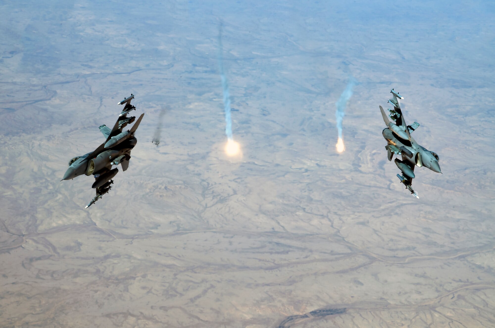 Two U.S. Air Force F-16 Fighting Falcons assigned to the 555th Expeditionary Fighter Squadron, release flares over Iraq, Feb. 6, 2020.