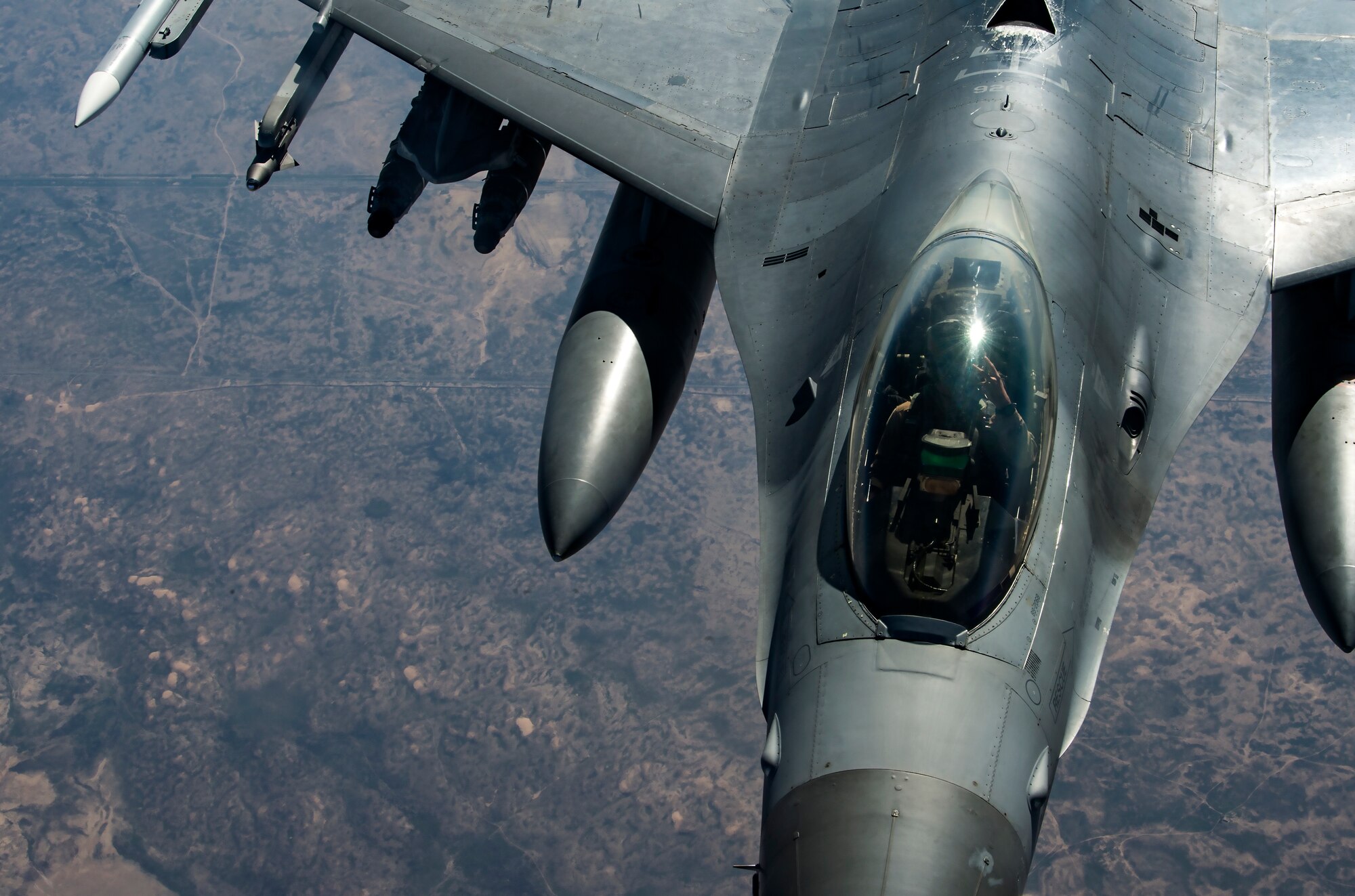 A U.S. Air Force F-16 Fighting Falcon pilot assigned to the 555th Expeditionary Fighter Squadron waves over Iraq, Feb. 6, 2020.