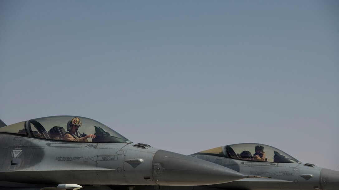 U.S. Air Force Capts. Mitchell Greene, left, and Jordan Scheffer, F-16 “Viper” Fighting Falcon pilots assigned to the 79th Expeditionary Fighter Squadron, wait to park at an undisclosed location in the U.S. Central Command area of responsibility, Feb. 14, 2020.